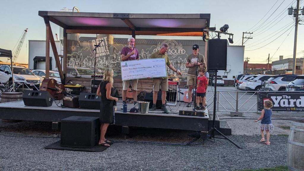 Ski Hut Scott “Potter” Neustal presents Chester Bowl Executive Director Dave Schaeffer with a $30,000 check supporting the Growing Up Chester campaign.