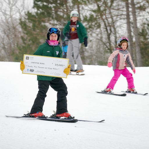 A Chester Bowl Cadet skis down the hill with the ceremonial check.
