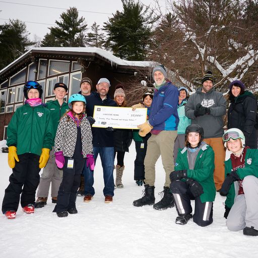 Eric Swanson presents Chester Bowl staff and volunteers with Loll Design’s donation to Growing Up Chester.