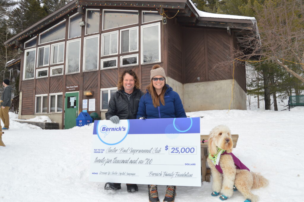 Jason Bernick and his family outside the Thom Storm Chalet with their ceremonial check supporting Chalet expansion and renovation.