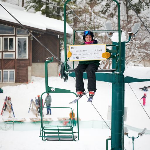 The ceremonial check gets a ride up the chairlift!