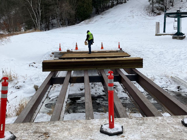 City crews built the bridge, installing the steel beams on the new abutments, and then placing the wooden decking.